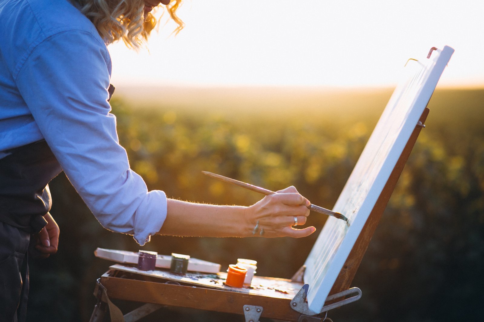 Hands of an artist with brush close up